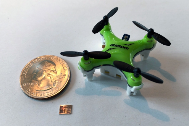 A new computer chip, smaller than a U.S. dime and shown here with a quarter for scale, helps miniature drones navigate in flight.