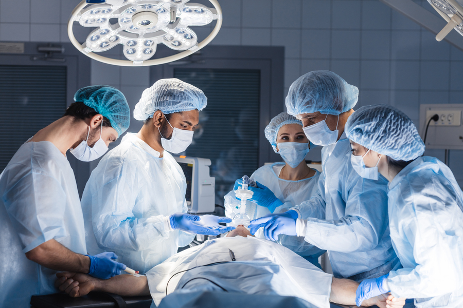 doctors around a patient in an operating room