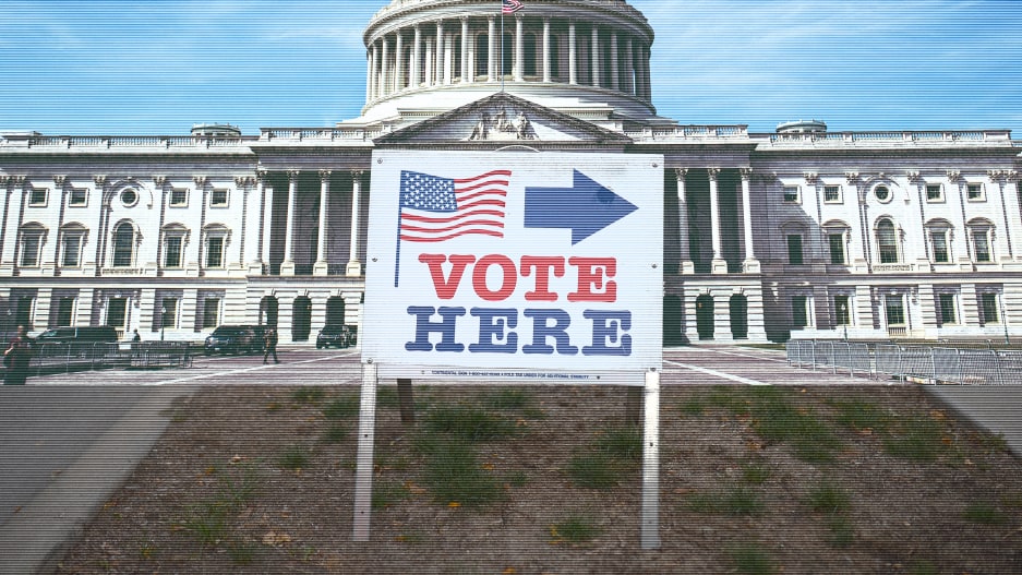a sign in front of the capitol building that says vote here