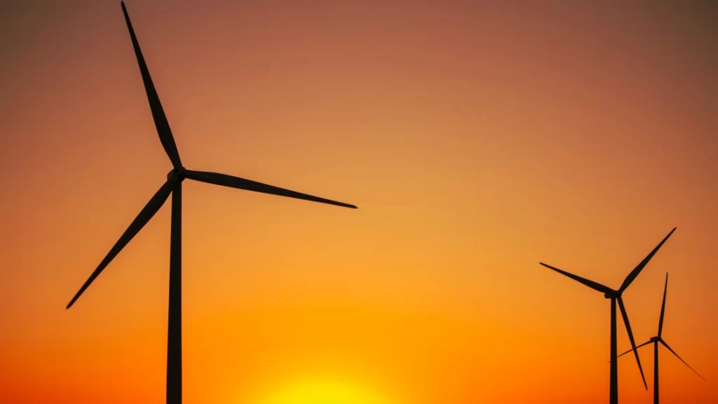 modern windmills in front of a sunrise