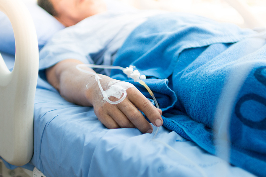 a patient in a hospital bed with an IV