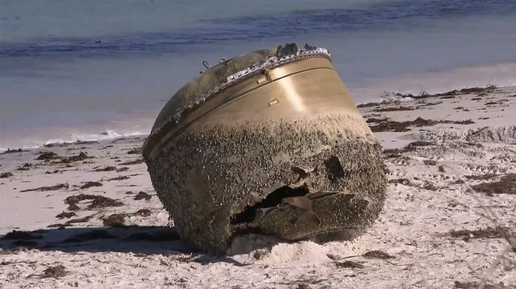 A large, cylindrical object washed up on an Australian beach