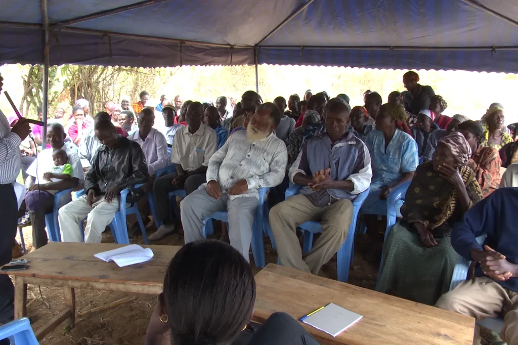 Residents of a Kenyan village gathered to learn they will receive UBI payments from GiveDirectly.
