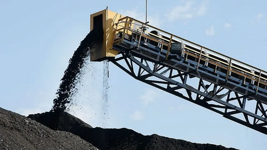 A coal extractor dumping coal onto a pile