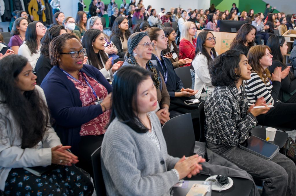 A diverse group of women in the audience of the Women in Data Science conference.