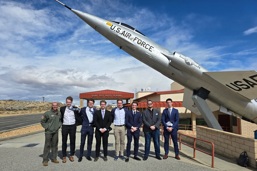 the developers of MIx posing beneath the wing of an US Air Force jet