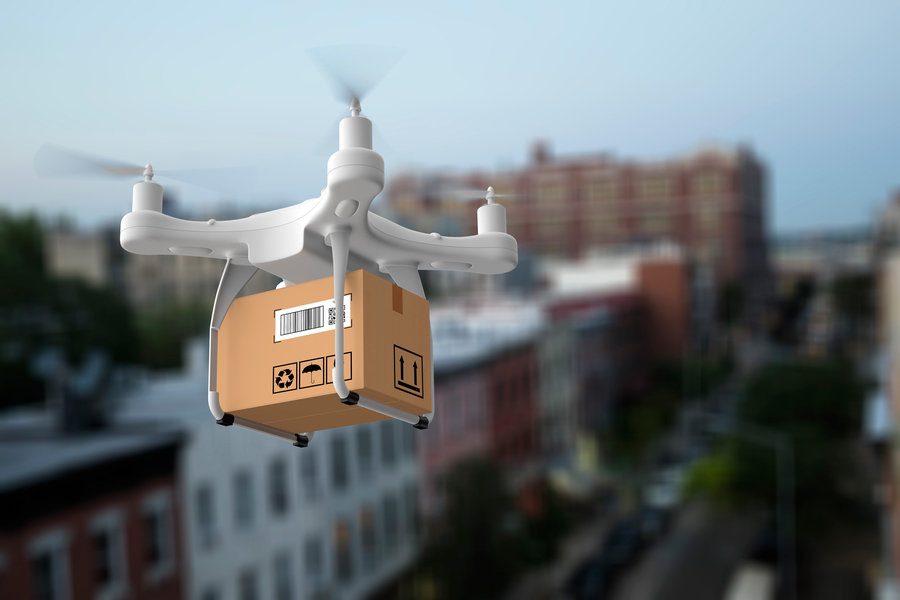 a drone carrying a package over a city