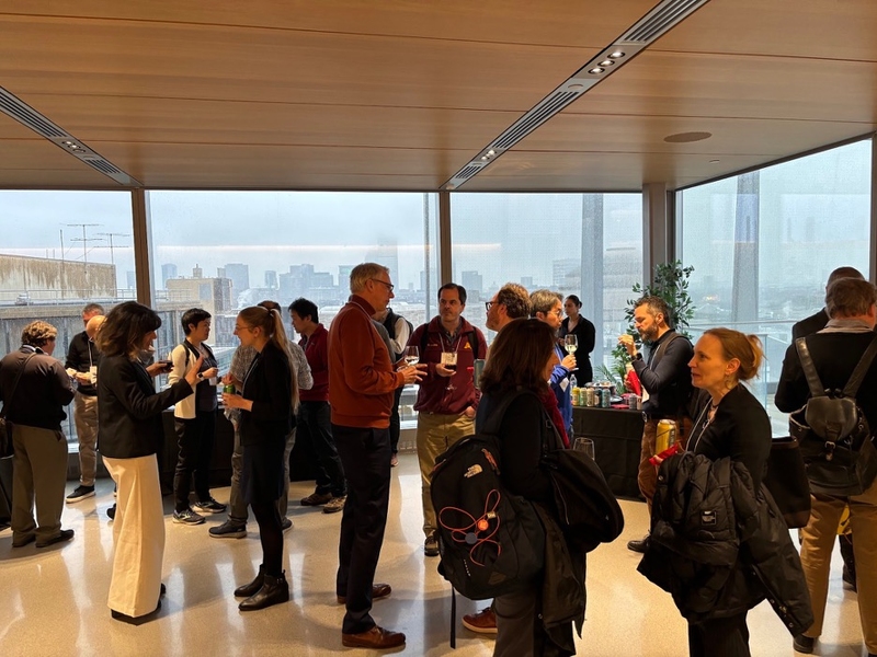 AI+MPS Workshop attendees discus the day’s proceedings at a reception.